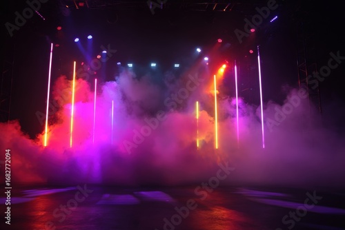 Stage lights show vibrant colors through smoky haze