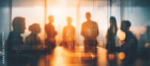 Blurred silhouettes of people in a meeting