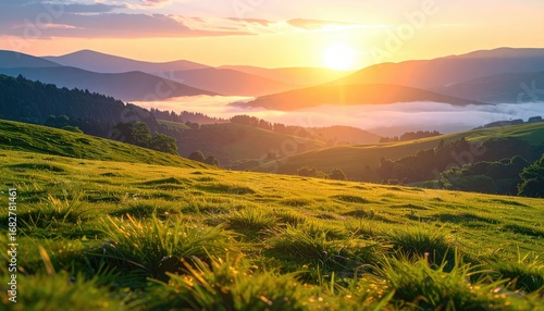 Sunrise over rolling hills and distant mountains, with morning mist filling valleys, bathed in golden light