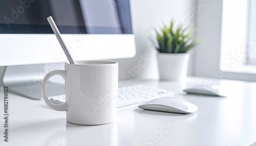 Clean workspace featuring a mug with a straw, a modern computer, keyboard, mouse, and a small potted plant, bathed in bright natural light