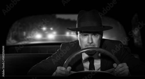 Slika na platnu Criminal man with a hat, escaping from the police at night while driving his car