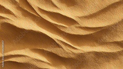 Fine sand texture in warm golden tones with natural small ripples and shadows, captured as a seamless background 