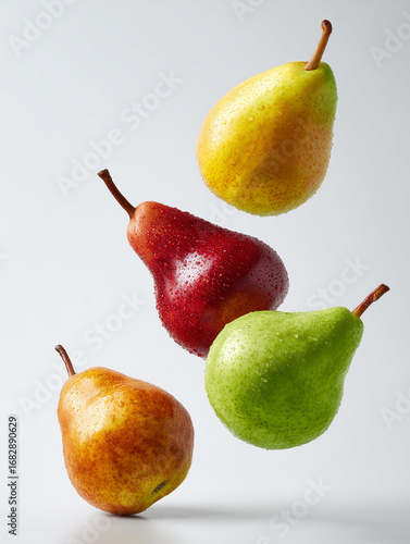 Floating pears in various colors showcasing freshness and texture against a light background