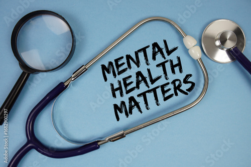 Mental Health Matters text with Stethoscope and magnifying glass on blue background