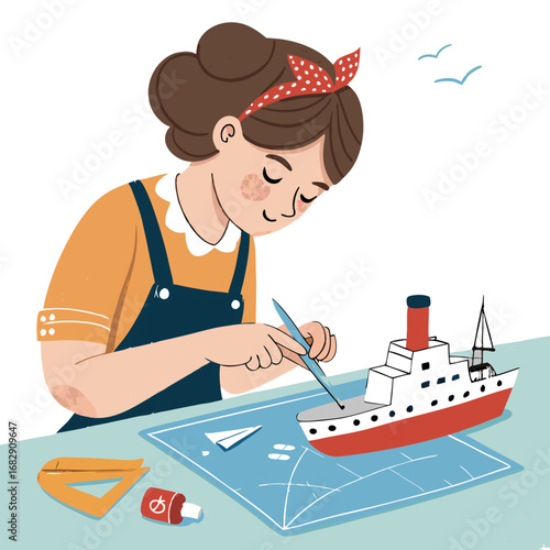 A young girl with a red polka dot headband is focused on building a model ship.
