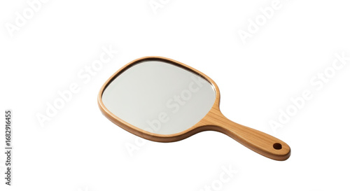 Wooden mirror with handle lies on a surface. Beauty accessory, reflection tool, grooming, vanity, skincare, lifestyle.