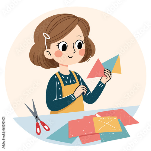 Cute girl doing paper crafts at a table.