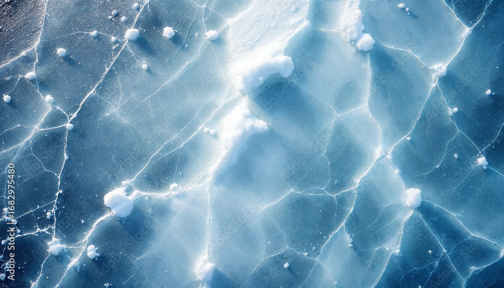 Obraz premium Top-down view of frozen lake surface with cracks and frost patterns 