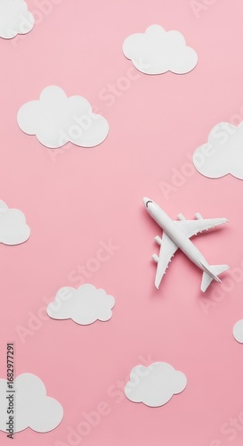 Wallpaper Mural Miniature airplane flying among pink sky and fluffy clouds background Torontodigital.ca