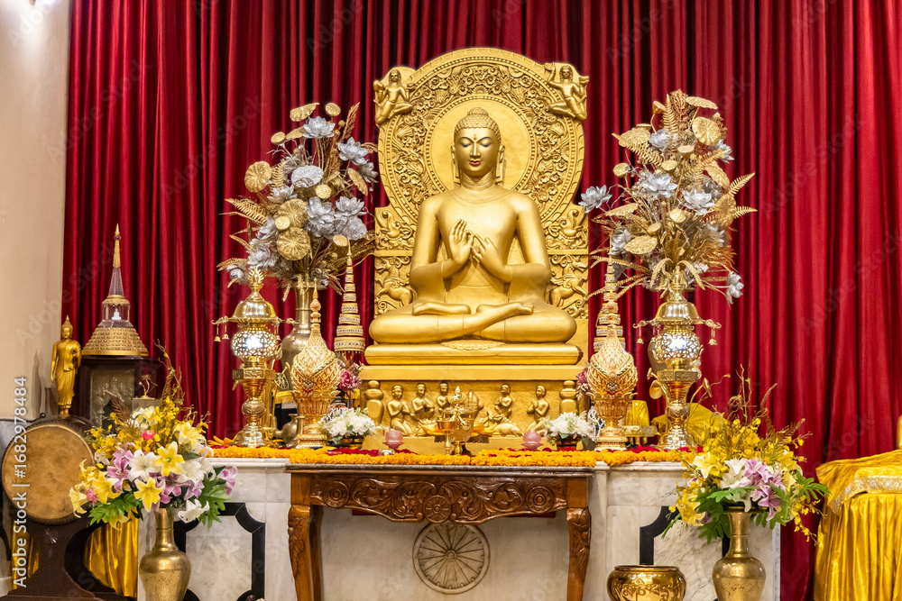 Fototapeta premium isolated holy statue of golden buddha at monastery at indoor