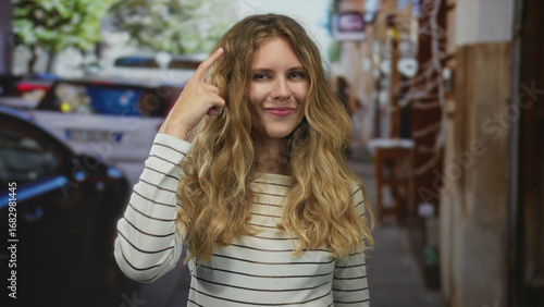 Wallpaper Mural Woman head pointing idea thinking concept shown by blonde young subject standing on street urban scene. Torontodigital.ca