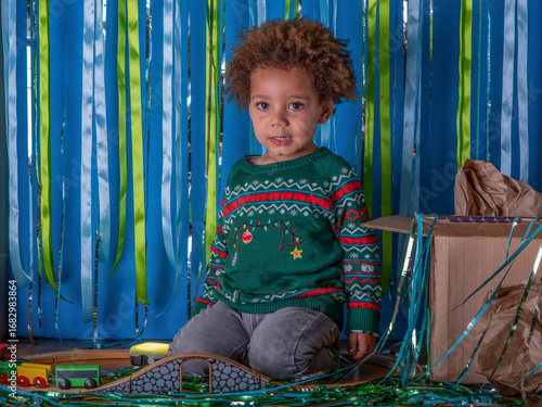 Obraz na plátne Toddler plays with a train set at a Christmas party