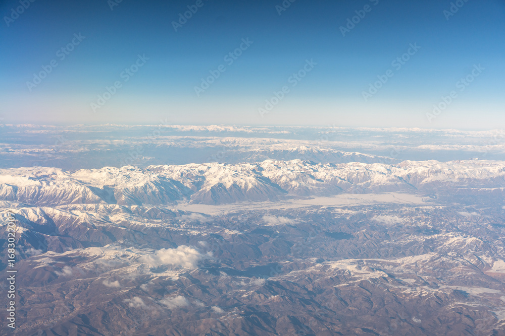 Fototapeta premium Plane Window View, Snow Mountains Aircraft Fly Landscape, Looking from Plane Cabin