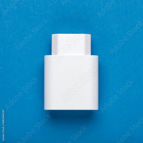 White rectangular adapter on a vibrant blue surface