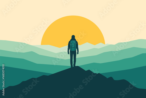A person with a backpack stands on a mountain peak looking at the sunrise over a layered mountain range