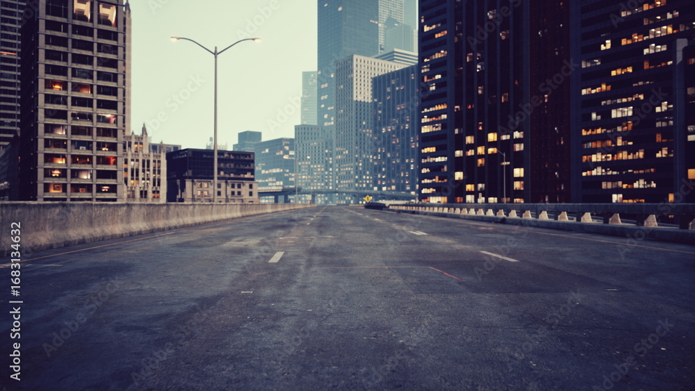 Fototapeta premium As day fades into night, a quiet city roadway stands empty, surrounded by towering buildings illuminated by glowing windows. The atmosphere feels still yet vibrant, hinting at stories untold.