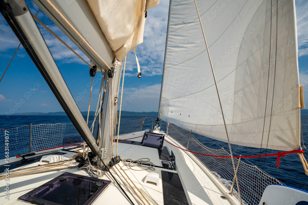 Fototapeta premium Sailing yacht moving at full speed with all sails up in the open sea near Croatia. Dynamic maritime adventure and freedom of ocean travel.