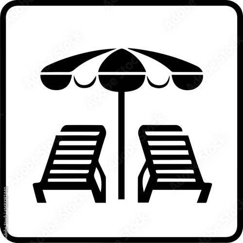 Black and white image of a beach scene with two lounge chairs and an umbrella. The chairs are positioned under the umbrella, and the scene conveys a relaxing and leisurely atmosphere