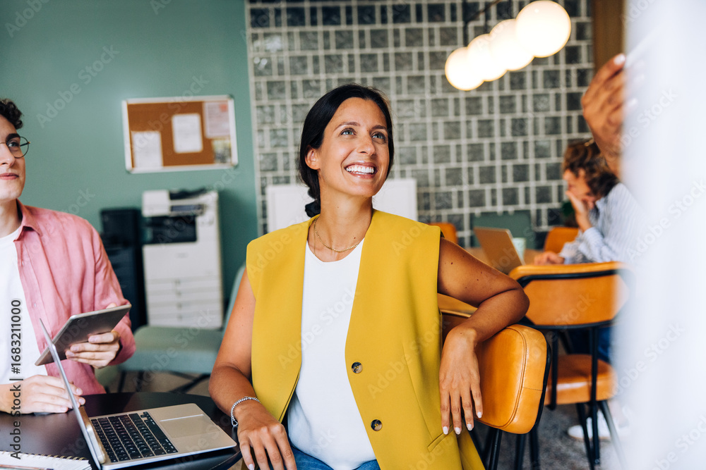 custom made wallpaper toronto digitalSmiling woman in a modern workspace during a group discussion