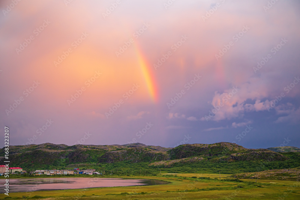 Obraz premium Rainbow in a stormy sky in the Teriberka Nature Park on the Barents Sea coast.