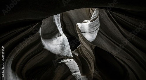 Striated Rock Formation in Shadowy Canyon with Light Beam