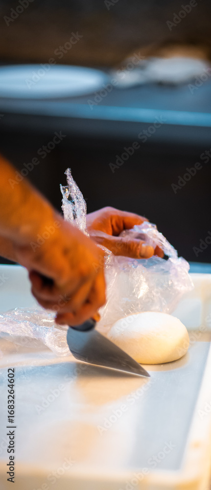 Obraz premium hands knead the raw pizza dough for pizza making