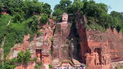 Leshan, China: Aerial drone footage of the famous Leshan giant Buddha stone statue  at the confluence of the Min River and Dadu River in Sichuan in China. Shot with a backward motion