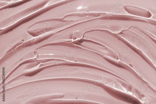 Beauty skin care product swatch sample. Liquid red skincare gel or serum texture smudge abstract background