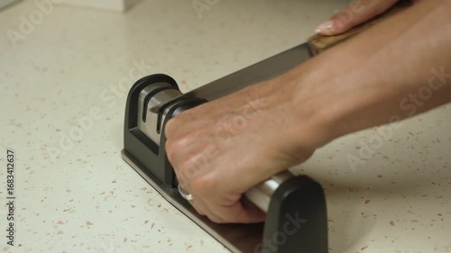 Woman sharpening a knife