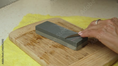 Woman sharpening a knife