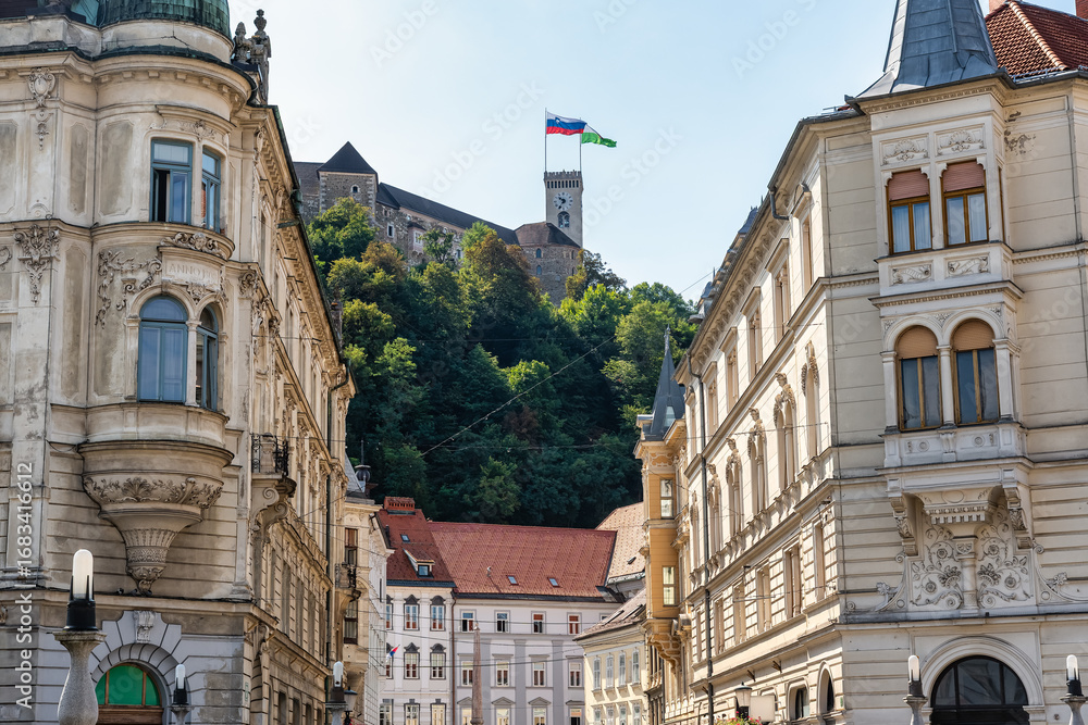 Fototapeta premium Historic buildings in Ljubljana city center with castle on top of the hill, Slovenia.