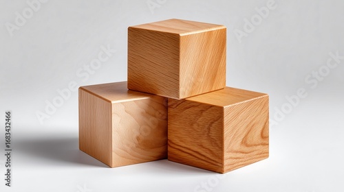 A set of three plain, geometric wooden blocks stacked neatly on a white surface