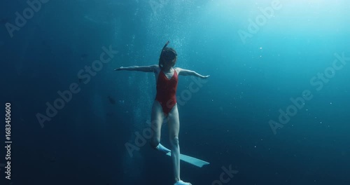 Wallpaper Mural Freediver woman swims in blue ocean. Sexy woman in red swimwear underwater in sea Torontodigital.ca