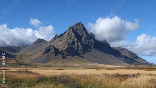 Dramatic mountain peak in a vast, dry landscape under a clear sky