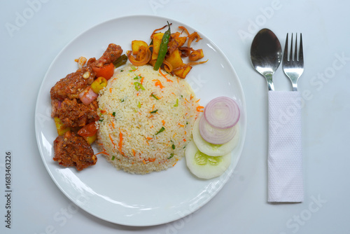 Fried Rice with Hot Devil Chicken and Fresh Onion and Cucumber Garnish.
