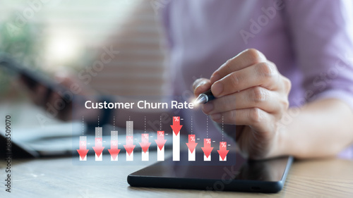 Fotografie Businesswoman analyzing customer churn rate with digital chart on tablet