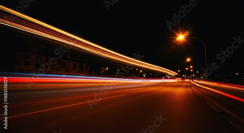 A city street at night, illuminated by streaks of light from moving vehicles, creating a mesmerizing display of motion and color.