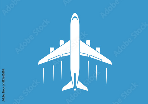 An overhead view of a white airplane in flight against a bright blue sky with its landing gear extended