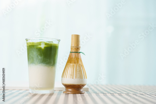 Wallpaper Mural Bamboo whisk with iced matcha latte in glass, beverage photo with copy space. Torontodigital.ca