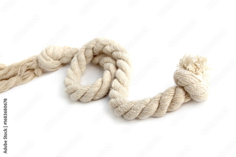 Fototapeta premium A twisting rope lies on a white background.