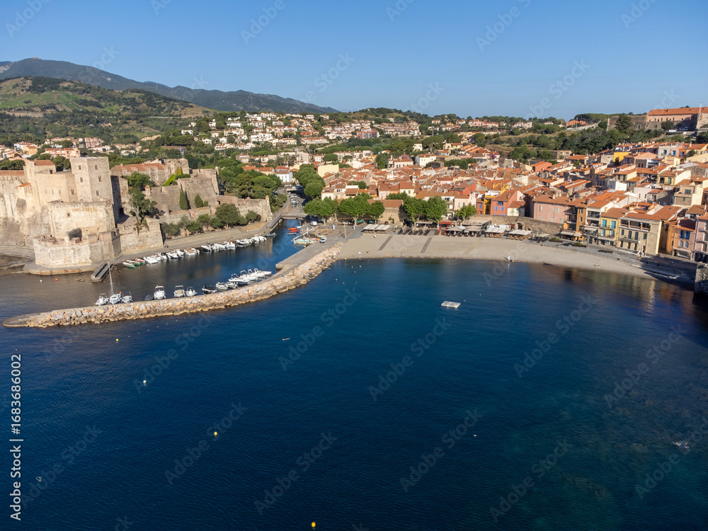 Fototapeta premium Aerial view of colourful Collioure, narrow streets and yellow, pink, orange houses, summer vacation destination town with historical buidings, beaches, Pyrenees-Orientales, France