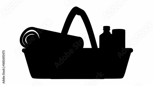 A black silhouette of a basket containing a rolled item and two bottles or containers inside the basket