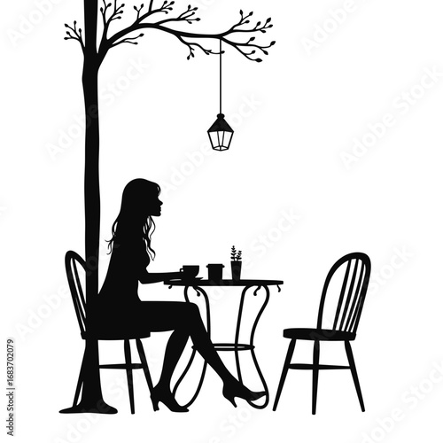 Silhouette of woman sitting alone at a cafe table under a tree  
