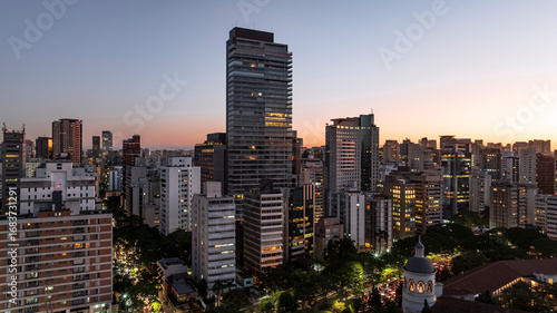 Fotografi Drone aerial sunset view of São Paulo city skyline at Avenida 9 de Julho with ta