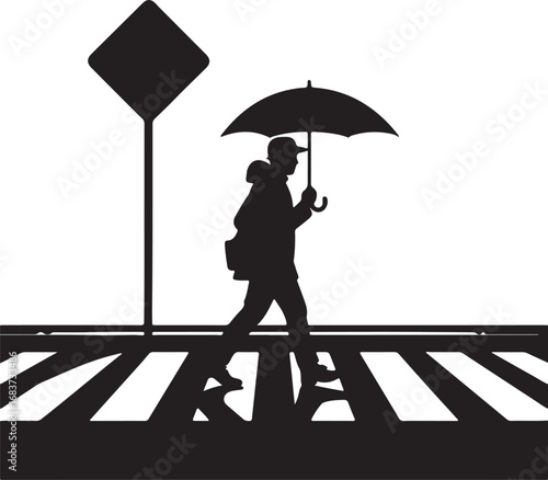 Silhouette of a person with an umbrella crossing a street at a crosswalk