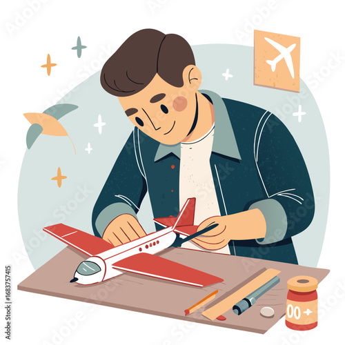 A young boy carefully assembling a red and white model airplane at his workbench.