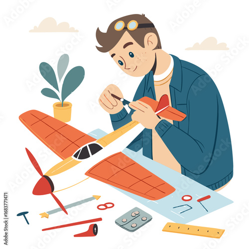 Young boy with goggles building a model airplane at a desk.