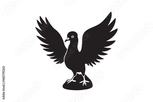 Black silhouette of a bird with outstretched wings on a rocky perch