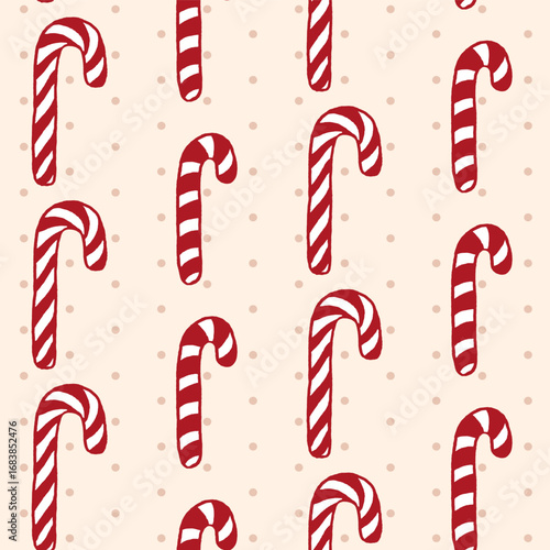 Vector seamless pattern with freehand drawn cartoon sugar candy canes on beige background with polka dots