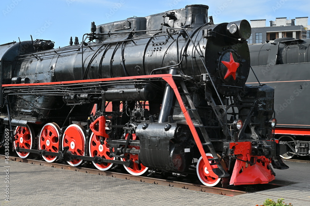 Naklejka premium Black locomotive with red wheels - first half of the 20th century.